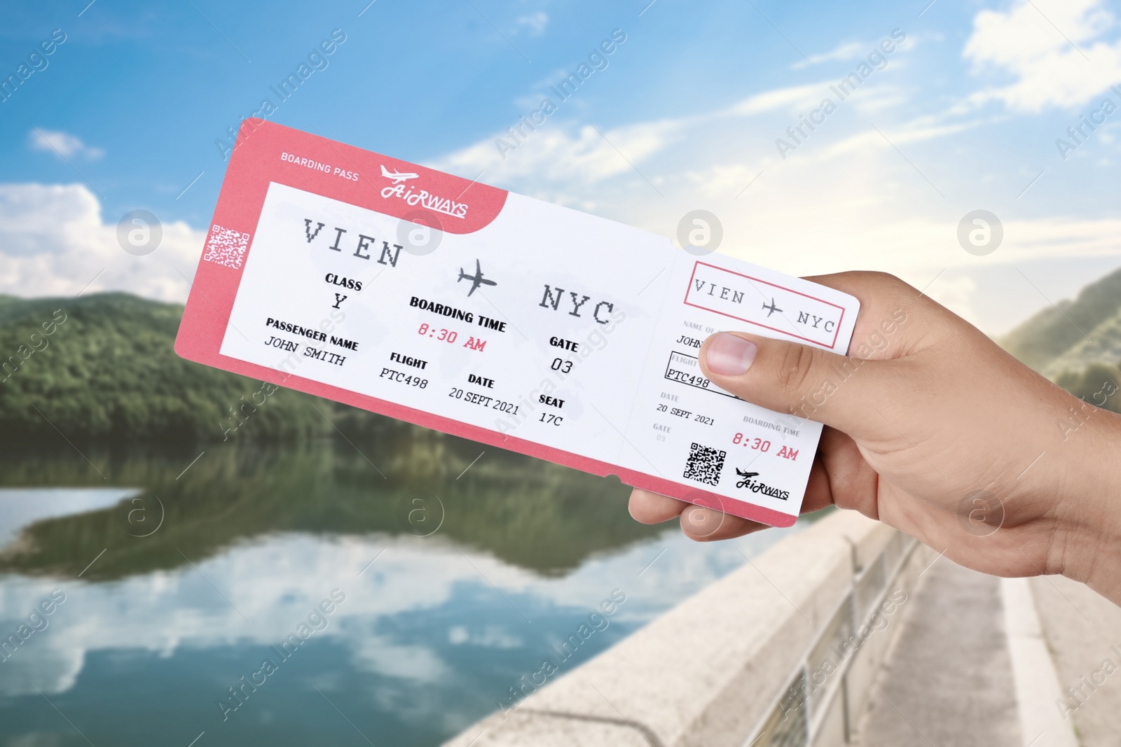 Image of Woman holding ticket near lake and mountains, closeup. Travel agency service