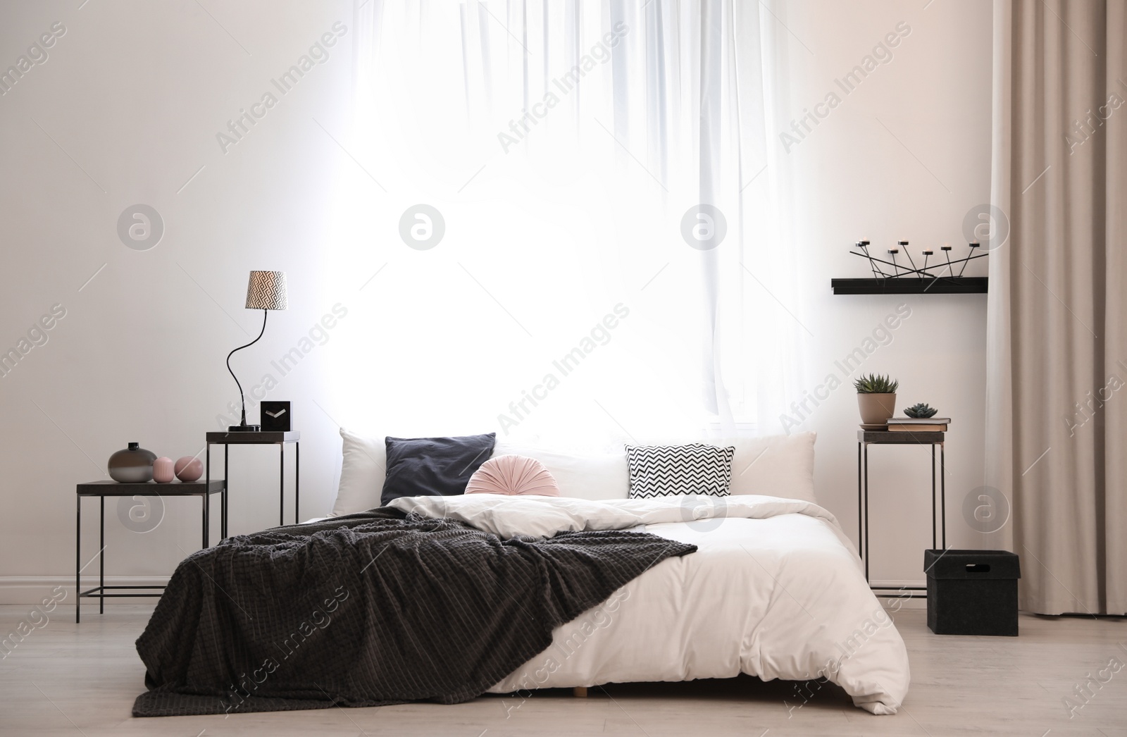 Photo of Stylish room interior with big comfortable bed