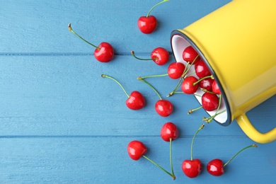 Flat lay composition with ripe red cherries on wooden background