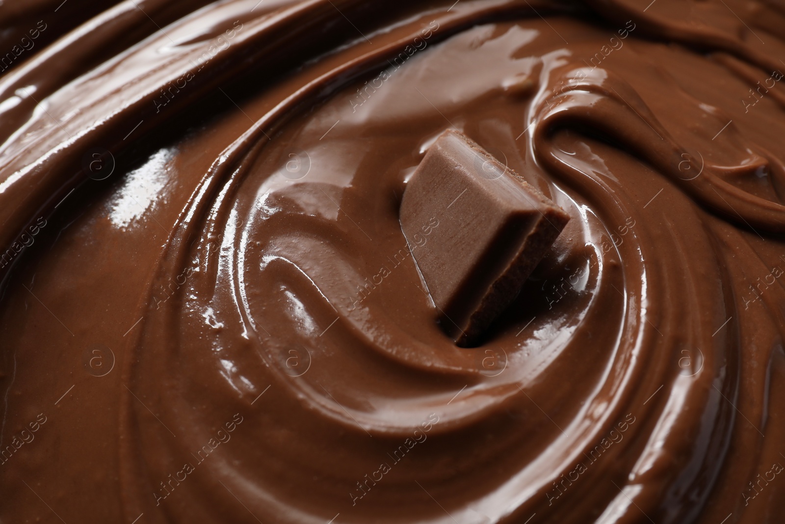 Photo of Tasty milk chocolate paste and piece as background, closeup