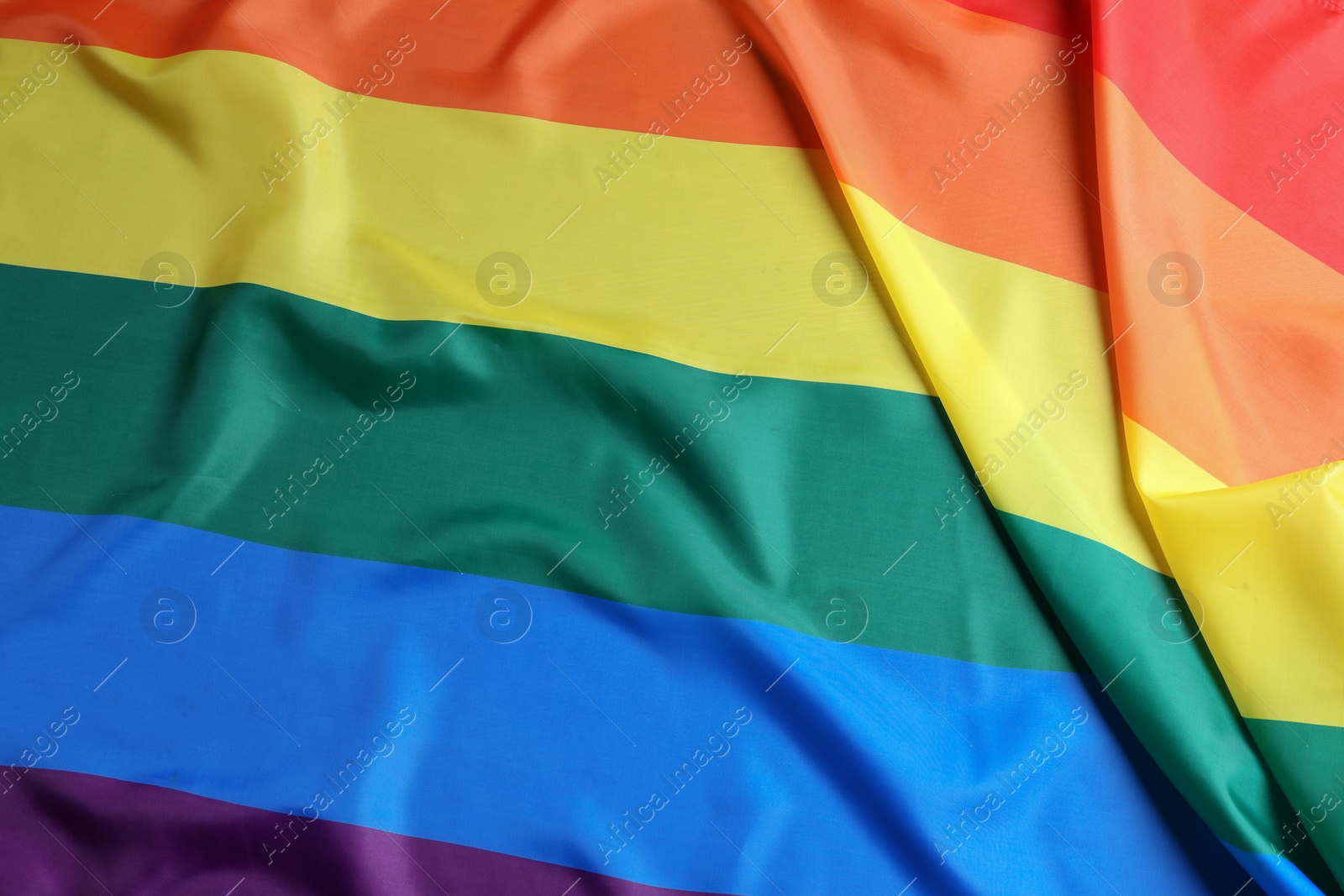 Photo of Bright rainbow gay flag as background. LGBT community