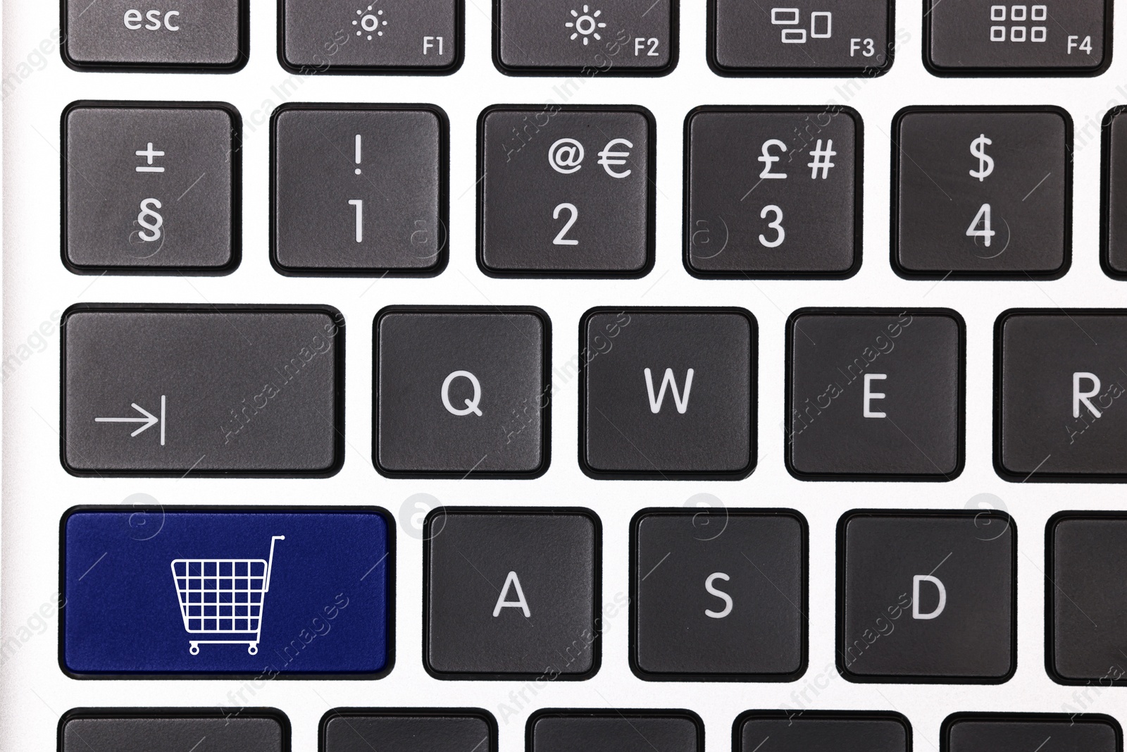 Image of Internet store. Blue button with shopping cart on computer keyboard, top view