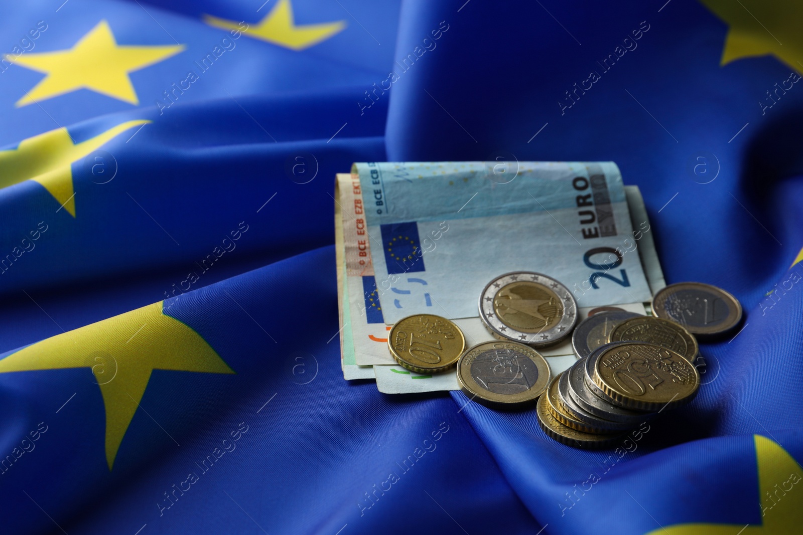 Photo of Coins and banknotes on European Union flag