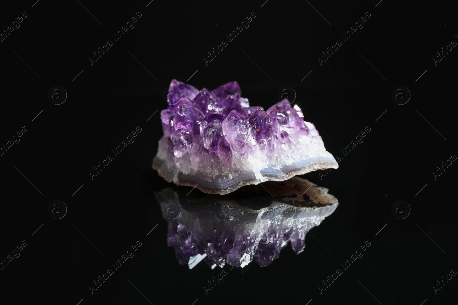 Photo of Beautiful purple amethyst gemstone on black background