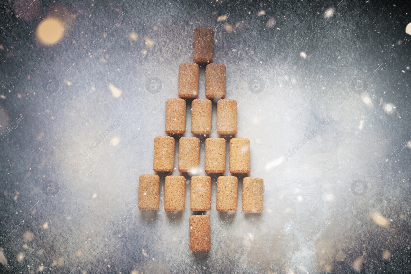 Image of Christmas tree made of wine corks on light grey table, top view