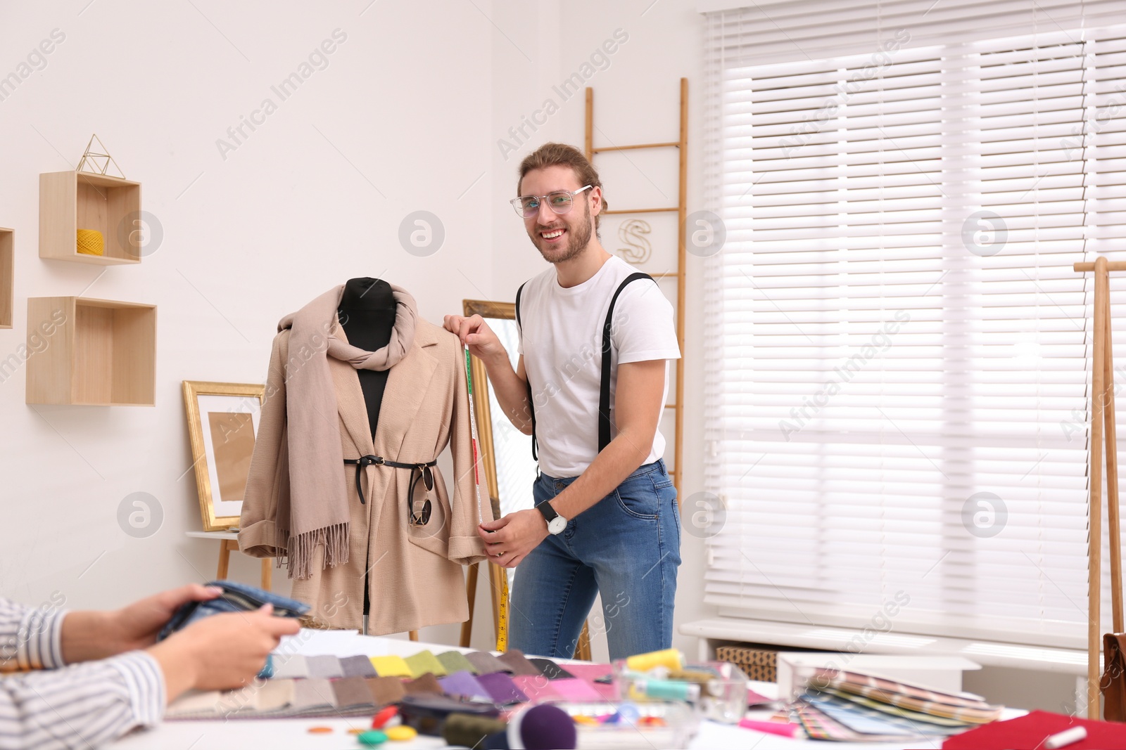 Photo of Fashion designer creating new clothes in studio