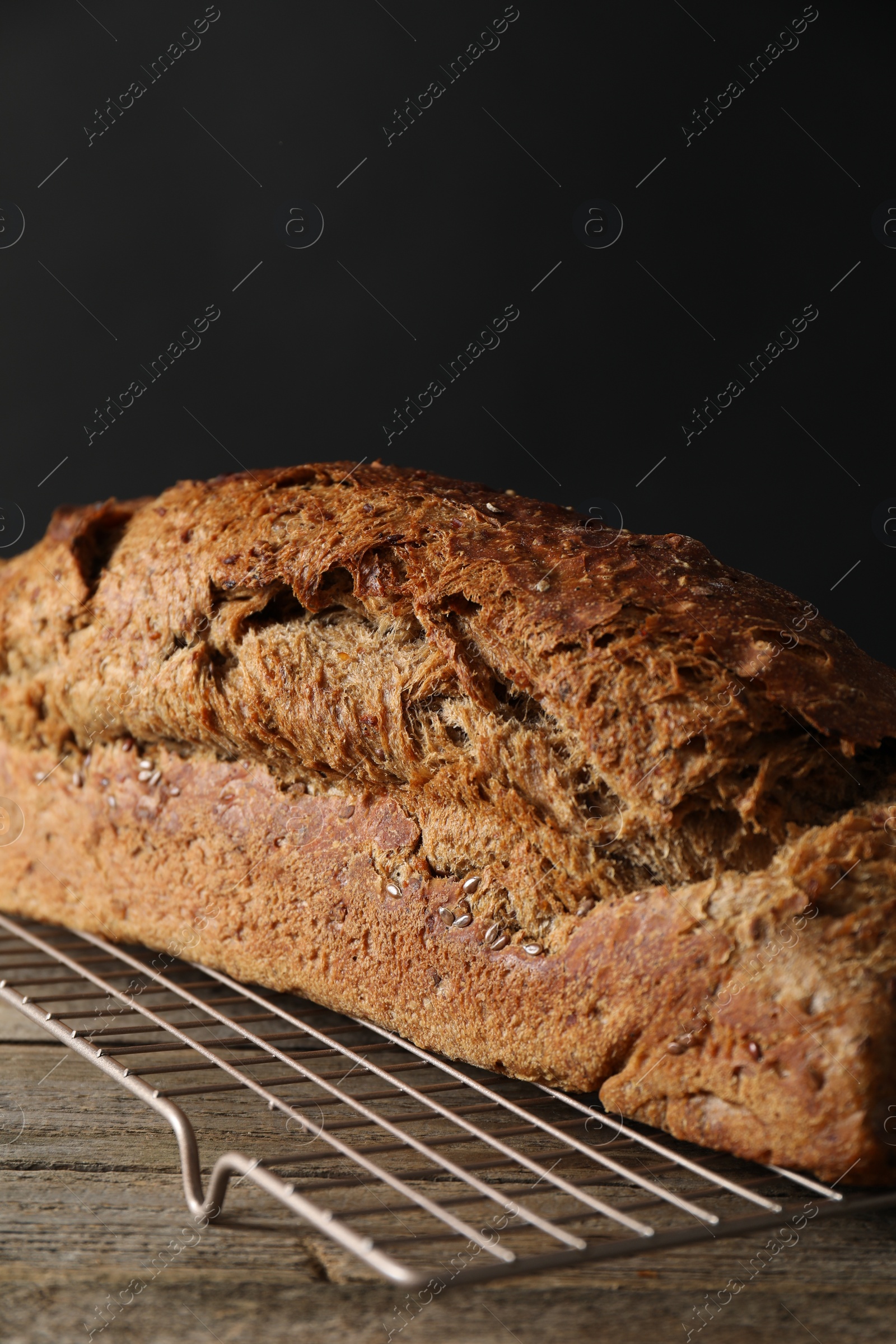 Photo of Freshly baked sourdough bread on wooden table, closeup