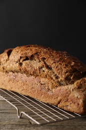 Freshly baked sourdough bread on wooden table, closeup