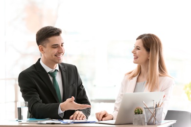 Young consultant working with client in office