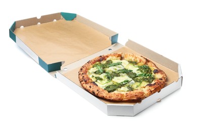 Photo of Delicious pizza with pesto, cheese and arugula in cardboard box on white background