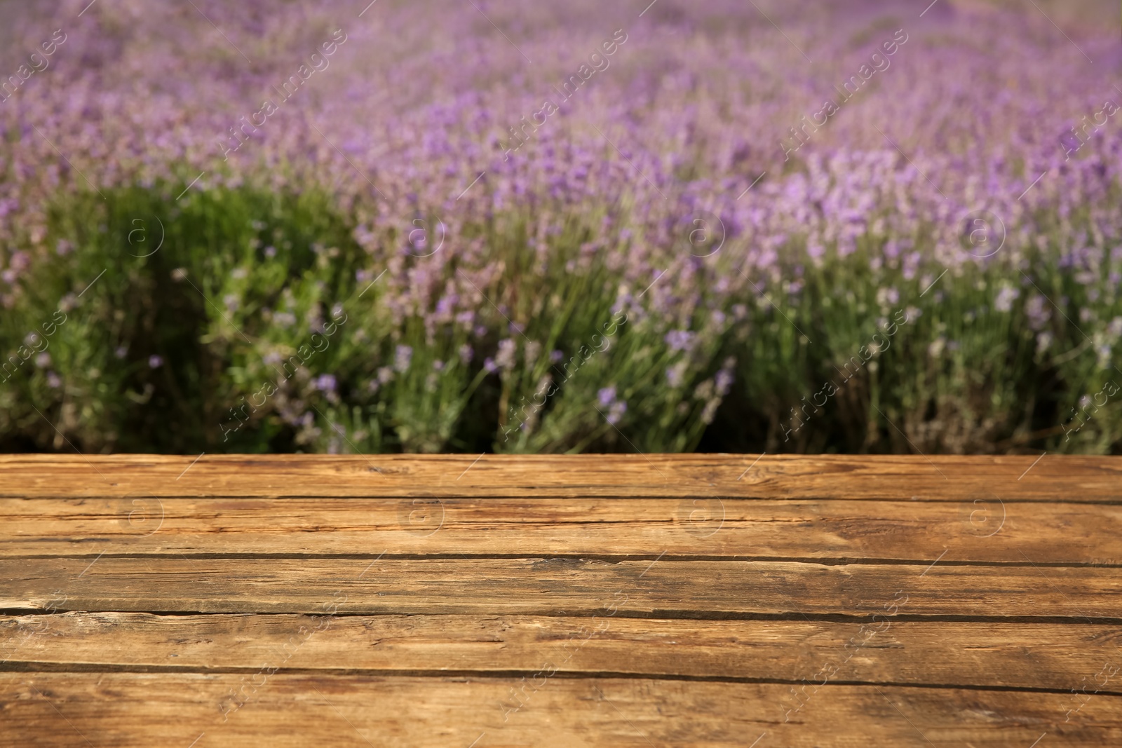 Photo of Empty wooden table in fresh lavender field