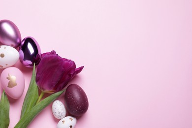 Flat lay composition with tulip and beautifully painted eggs on pink background, space for text. Easter celebration