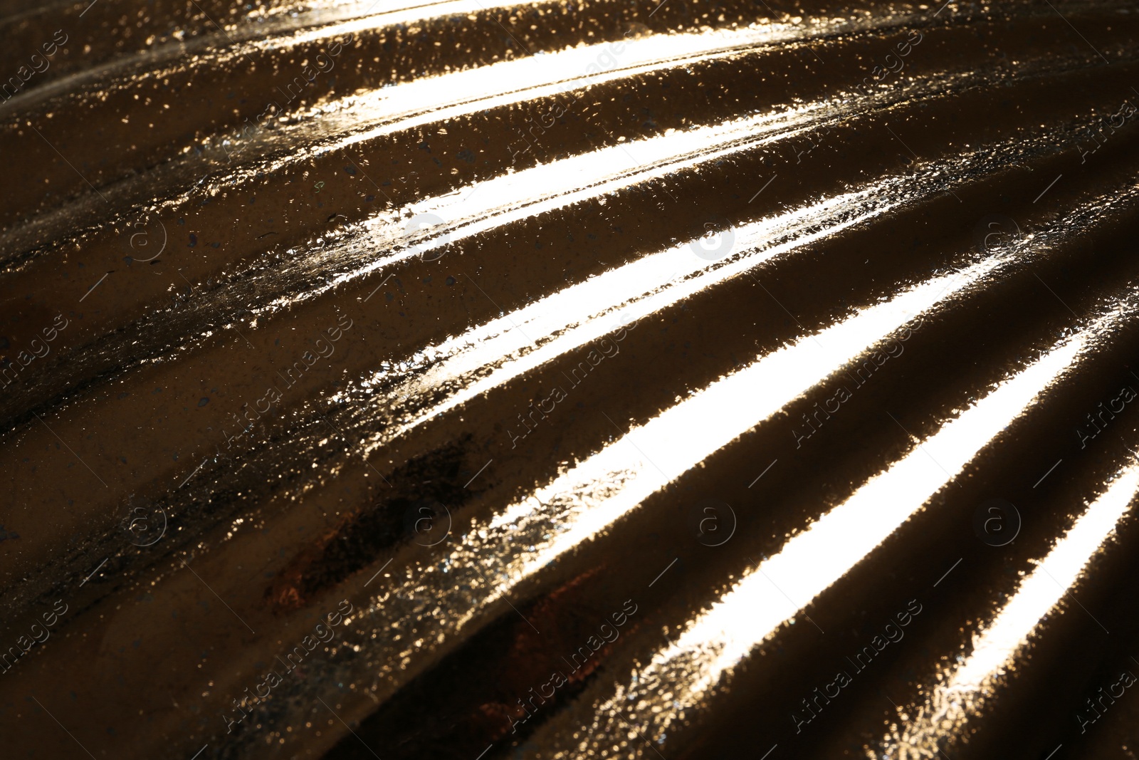 Photo of Corrugated golden texture as background, closeup view