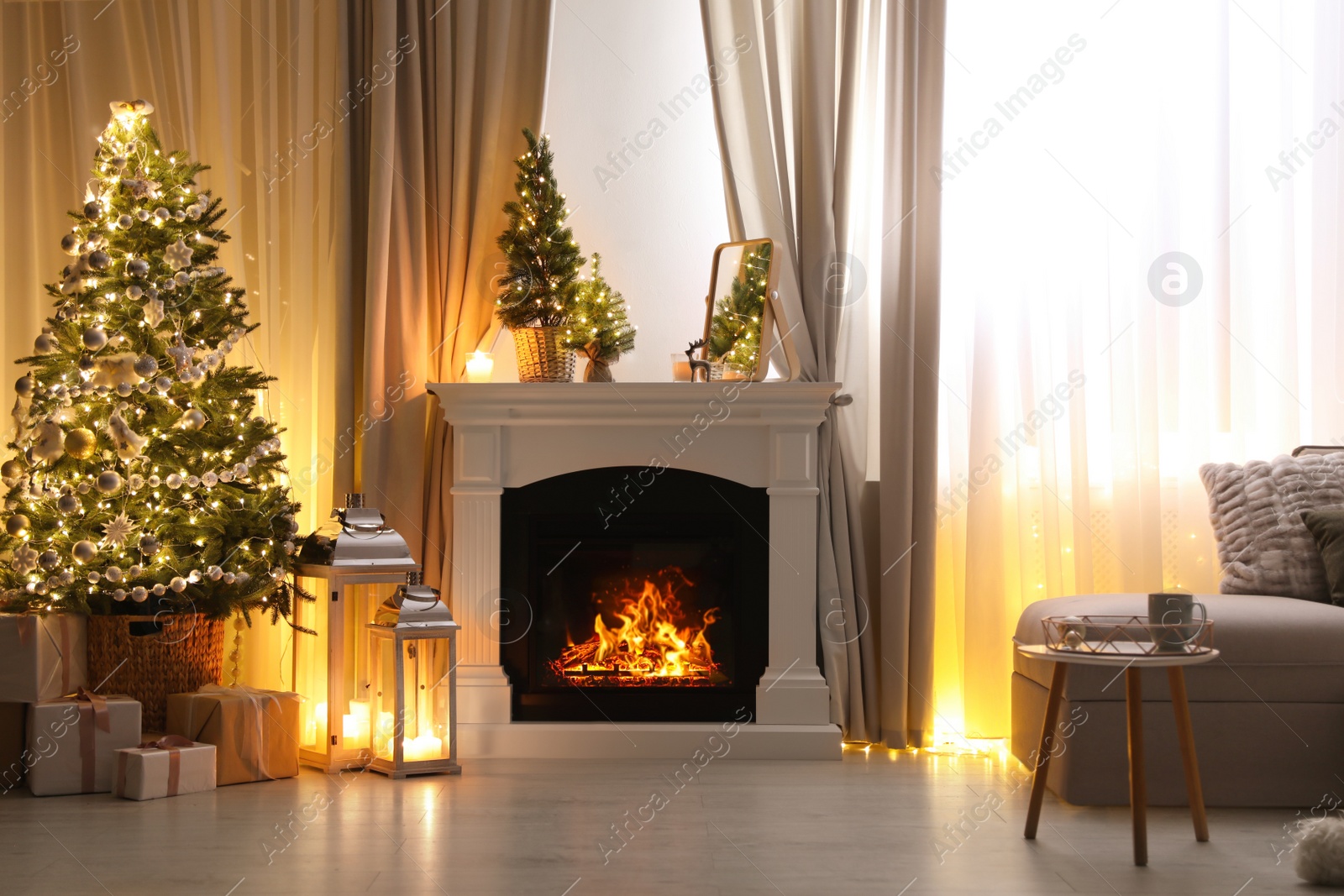 Photo of Stylish living room interior with beautiful fireplace, Christmas tree and other decorations