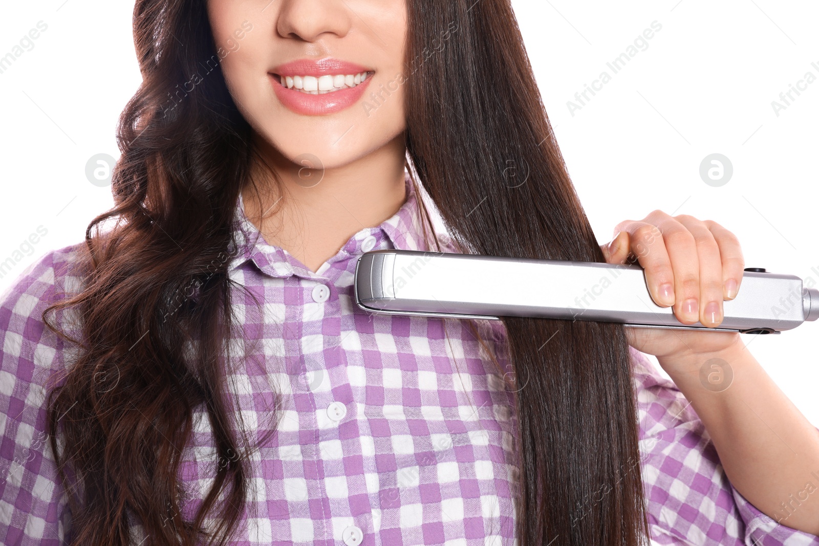 Photo of Happy woman using hair iron on white background, closeup