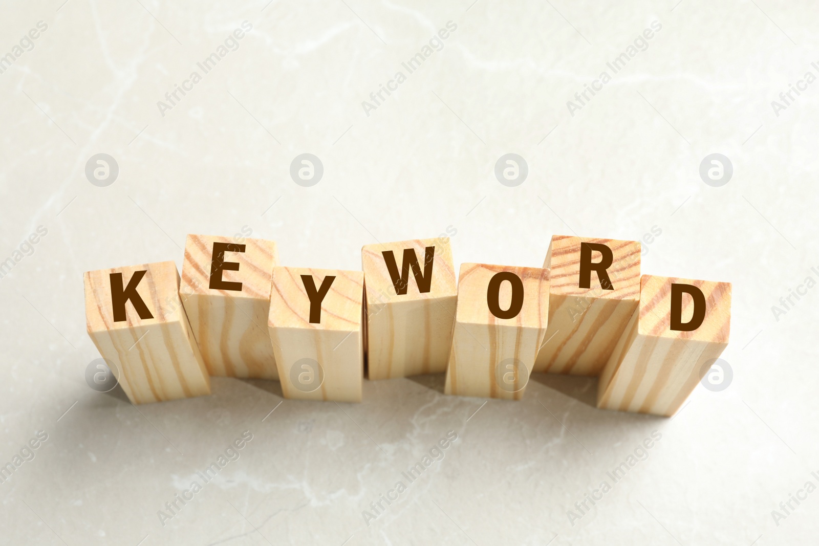 Photo of Blocks with word KEYWORD on white marble table