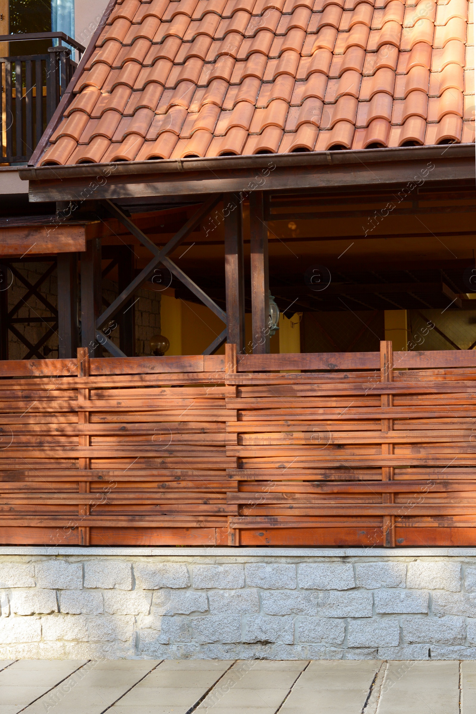 Photo of Wooden fence near house on sunny day outdoors