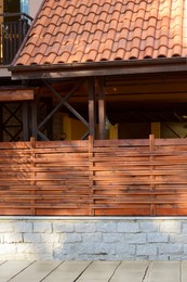 Wooden fence near house on sunny day outdoors