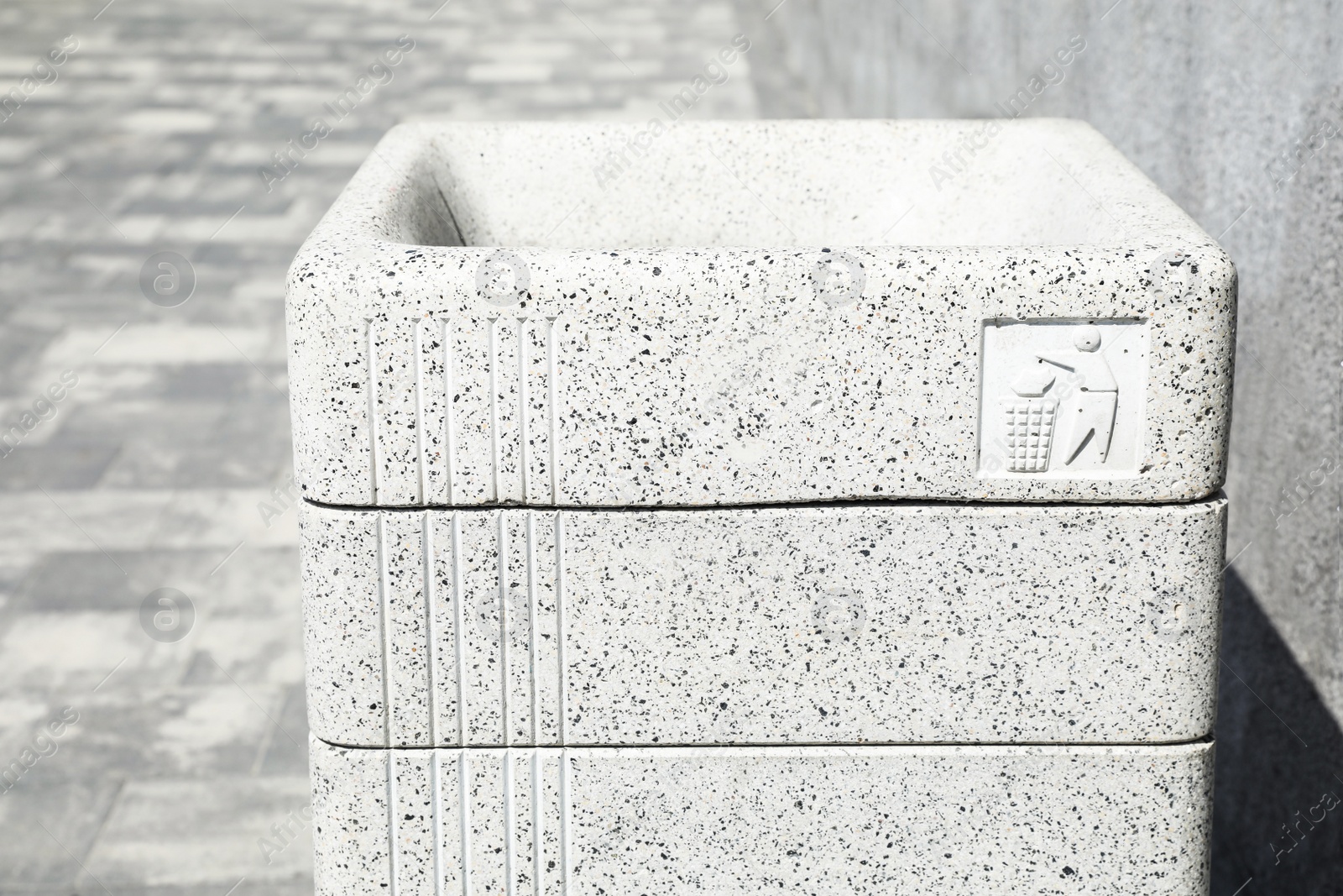 Photo of Modern grey trash bin outdoors, closeup view