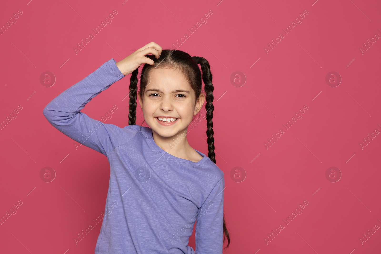 Photo of Little girl scratching head on color background, space for text. Annoying itch