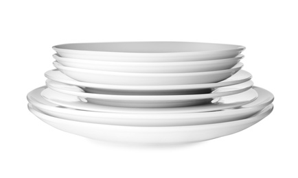 Photo of Stack of clean plates isolated on white