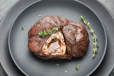 Photo of Delicious roasted beef meat with thyme on plate, closeup