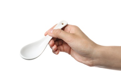 Woman holding clean ceramic miso soup spoon on white background, closeup