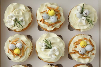 Tasty Easter cupcakes in box, top view