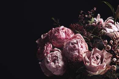 Photo of Beautiful bouquet of different flowers on black background. Floral card design with dark vintage effect