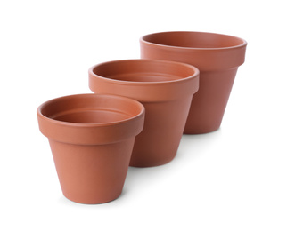 Stylish terracotta flower pots isolated on white