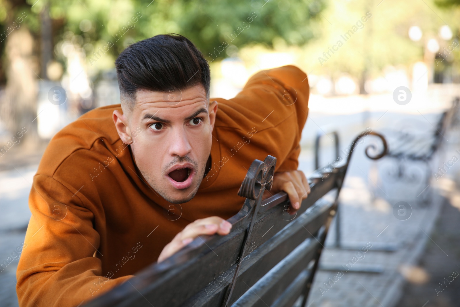 Photo of Jealous man spying on ex girlfriend in park