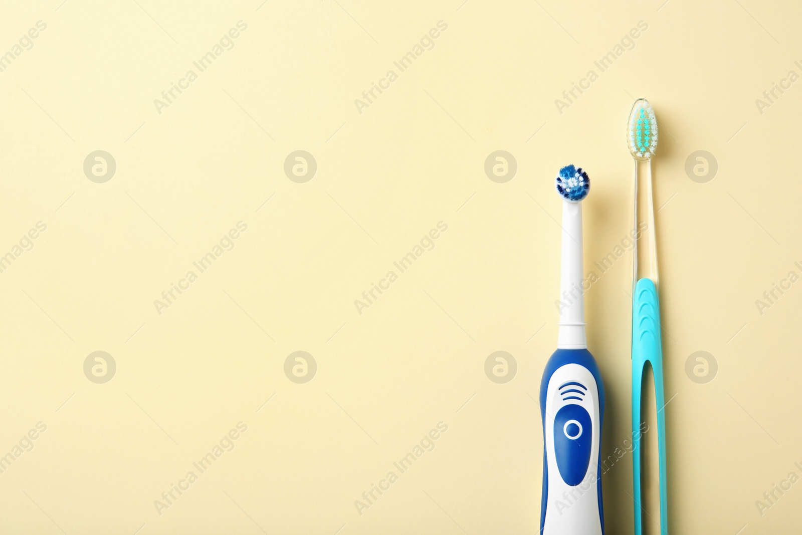 Photo of Manual and electric toothbrushes on color background. Dental care