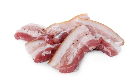 Slices of tasty pork fatback with spices on white background