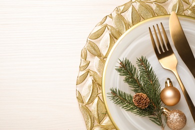 Beautiful Christmas table setting on white wooden background, top view. Space for text