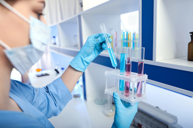 Photo of Scientist putting test tube in rack, closeup. Laboratory analysis