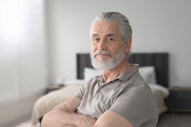 Photo of Portrait of handsome senior man at home