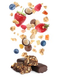 Tasty protein bars and granola with berries and nuts falling on white background