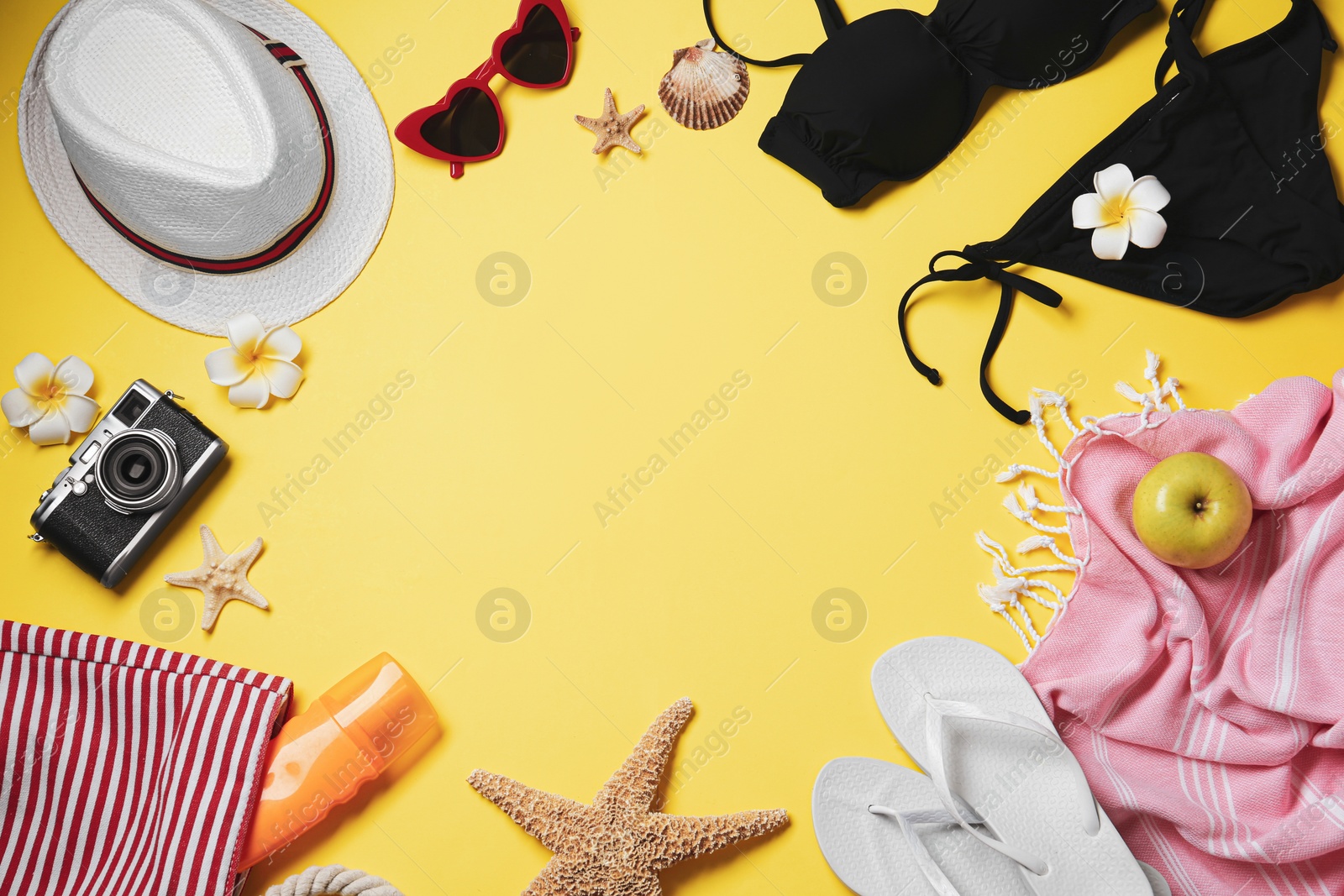 Photo of Frame made of beach objects on yellow background, flat lay. Space for text