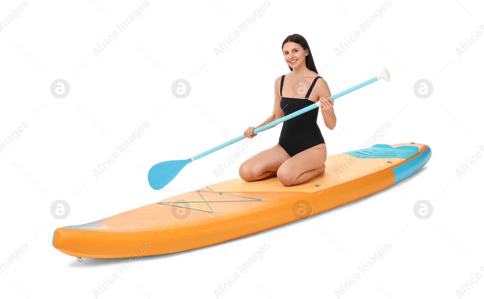 Photo of Happy woman with paddle on orange SUP board against white background