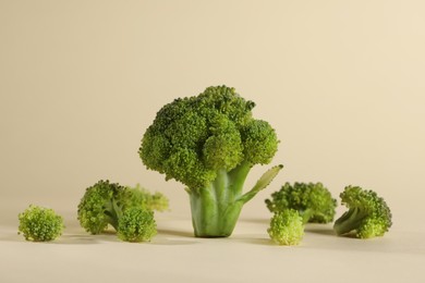 Photo of Fresh raw broccoli on beige background, closeup