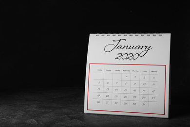Photo of Paper calendar on grey table, space for text. Planning concept