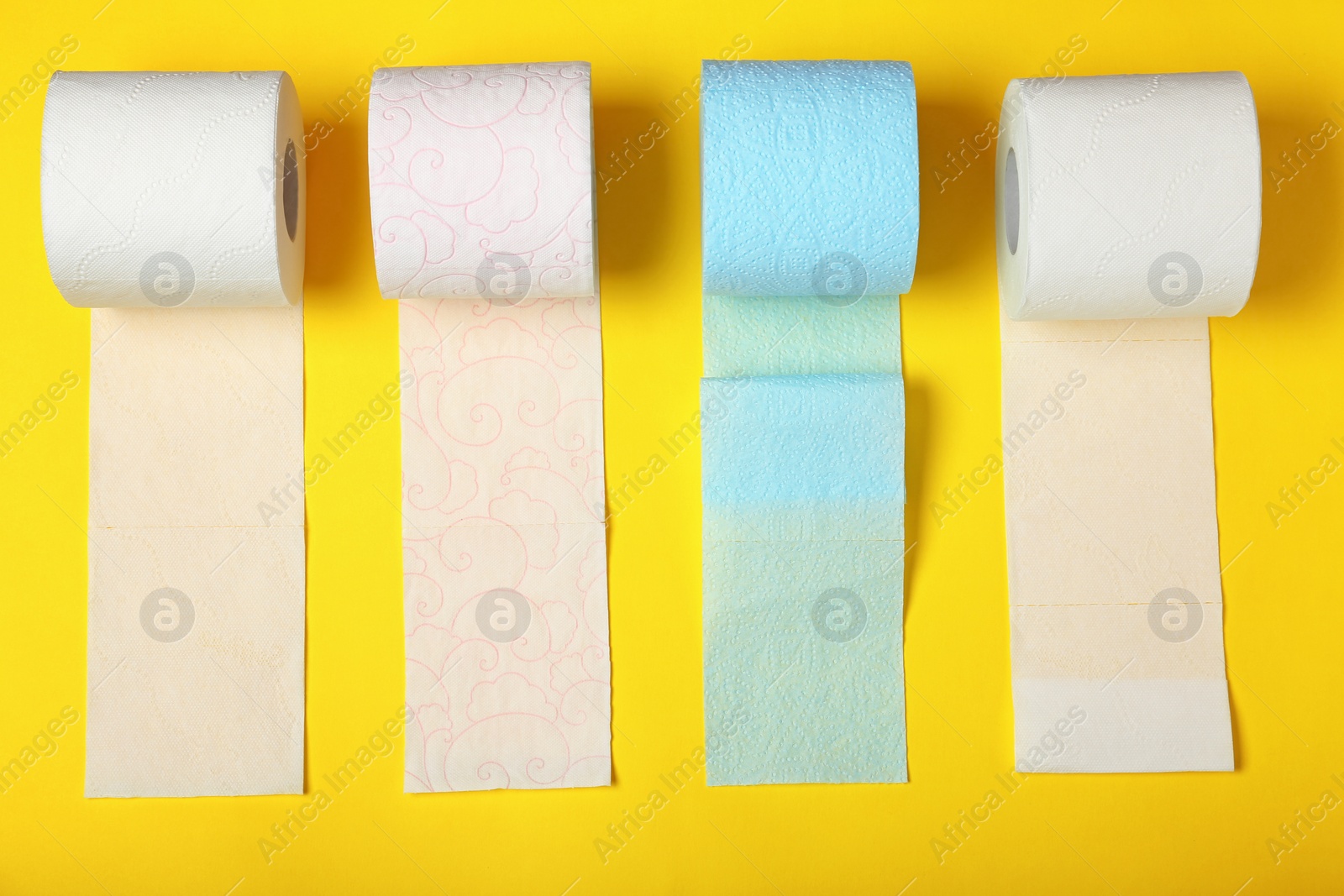 Photo of Flat lay composition with toilet paper on color background