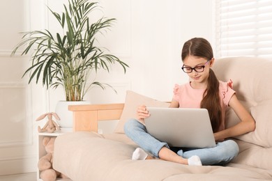 Photo of Girl with laptop on sofa at home
