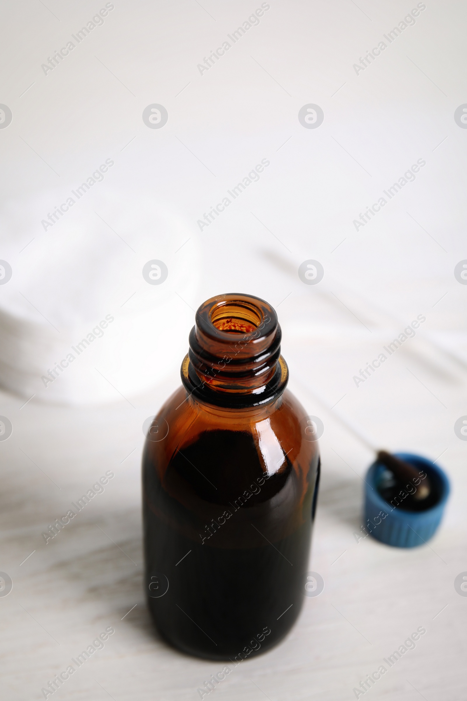 Photo of Bottle of medical iodine on white table, closeup