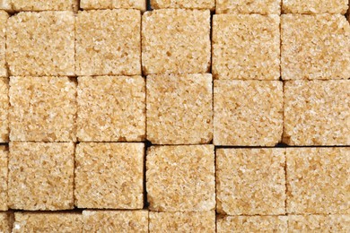 Photo of Brown sugar cubes as background, closeup view