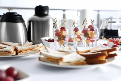 Table with different delicious snacks indoors. Coffee break