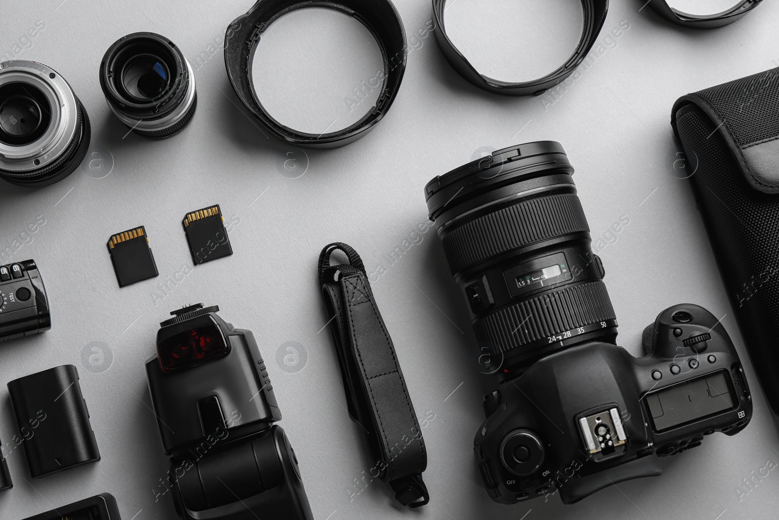 Photo of Flat lay composition with professional photographer equipment on light background