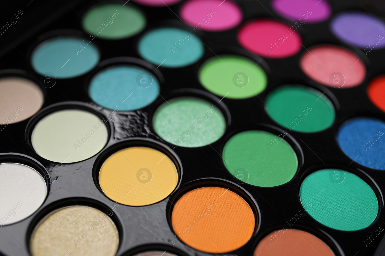 Photo of Beautiful eyeshadow palette as background, closeup. Professional cosmetic product