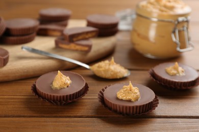 Photo of Delicious peanut butter cups on wooden table