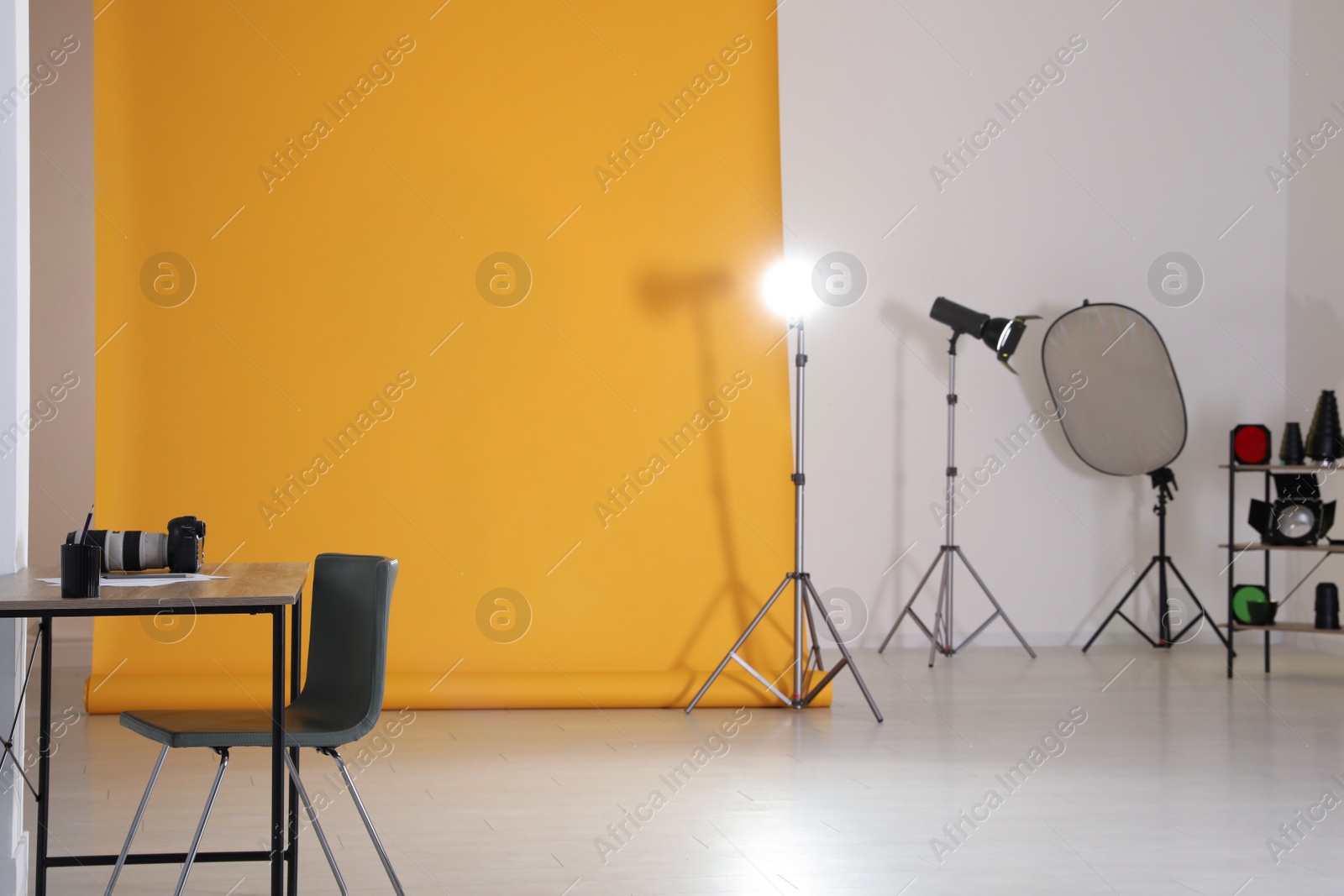 Photo of Photo studio interior with set of professional equipment and workplace